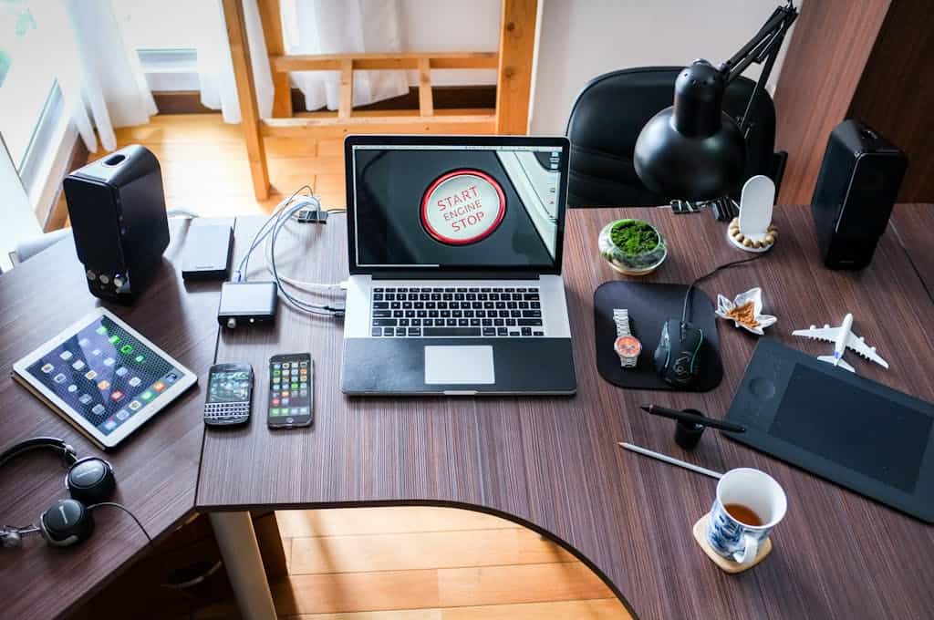 Black and White Laptop Computer on Brown Wooden Desk