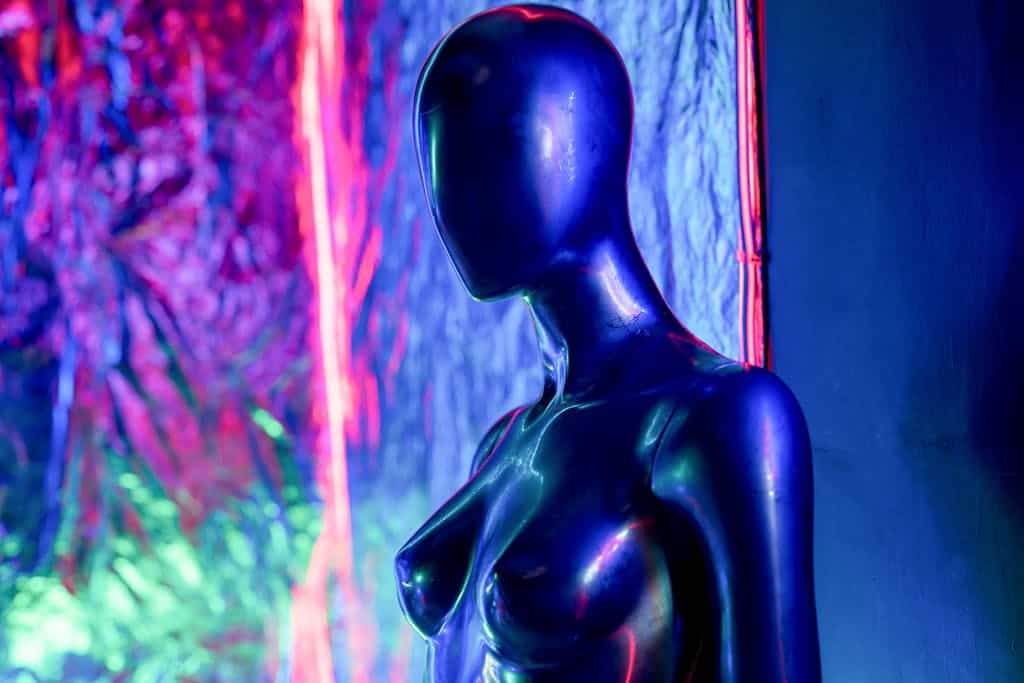 A Mannequin in Front of Neon Lights Background