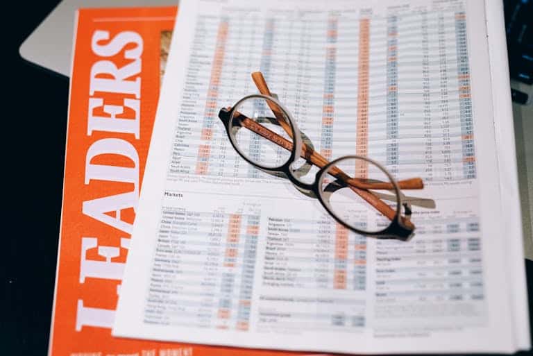 Black Framed Eyeglasses on White and Orange Paper