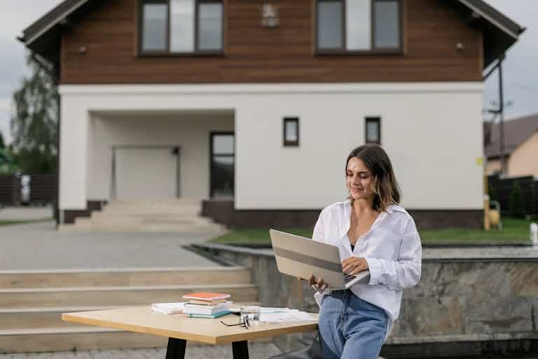 Woman Using a Laptop while Standing